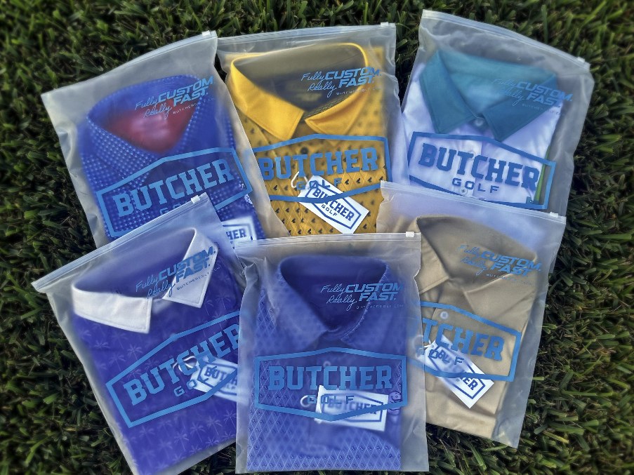 Butcher Golf polos packaged in clear individual garment bags with printed blue branding