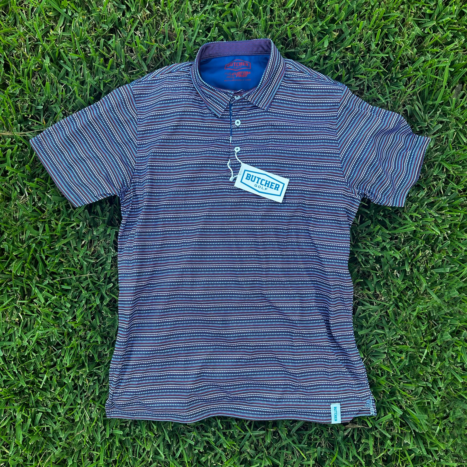 Comparison reference showing a plain stock corporate polo with a single applied chest logo.