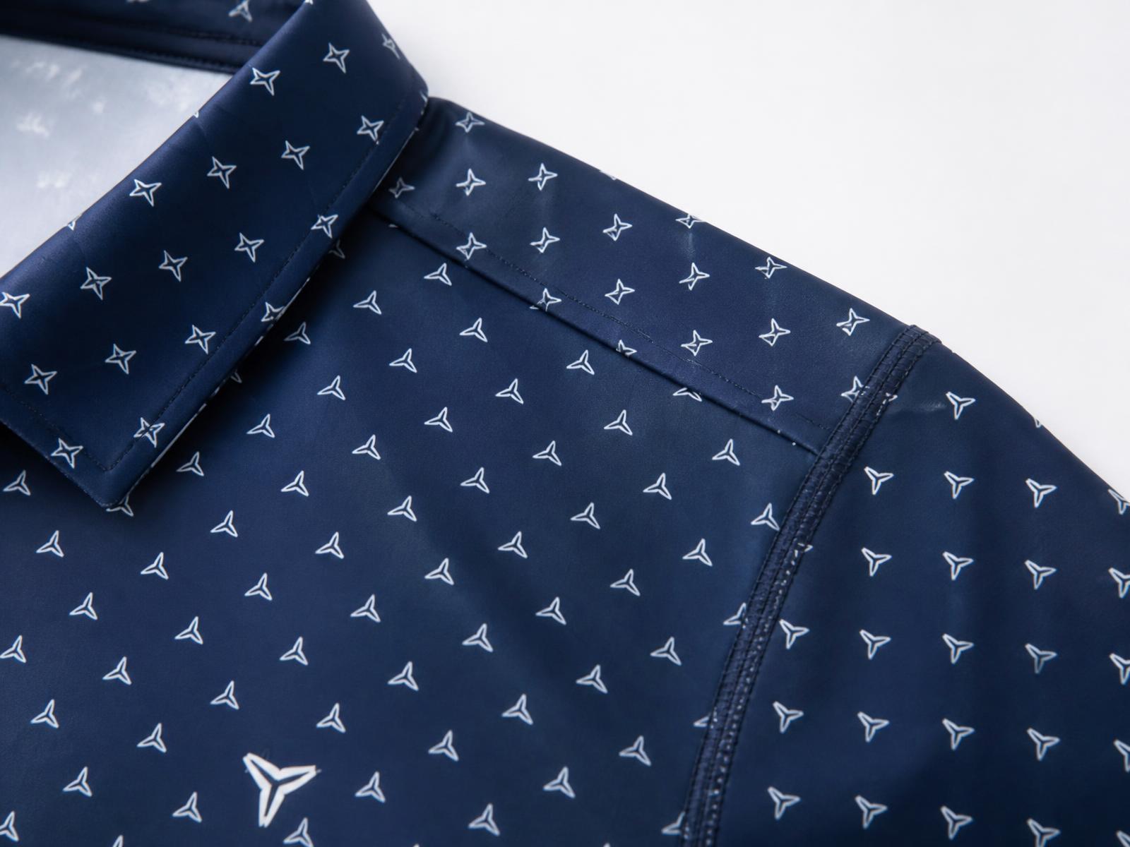 Construction and detail image showing smooth performance fabric, seams, pattern registration, collar, and logo.
